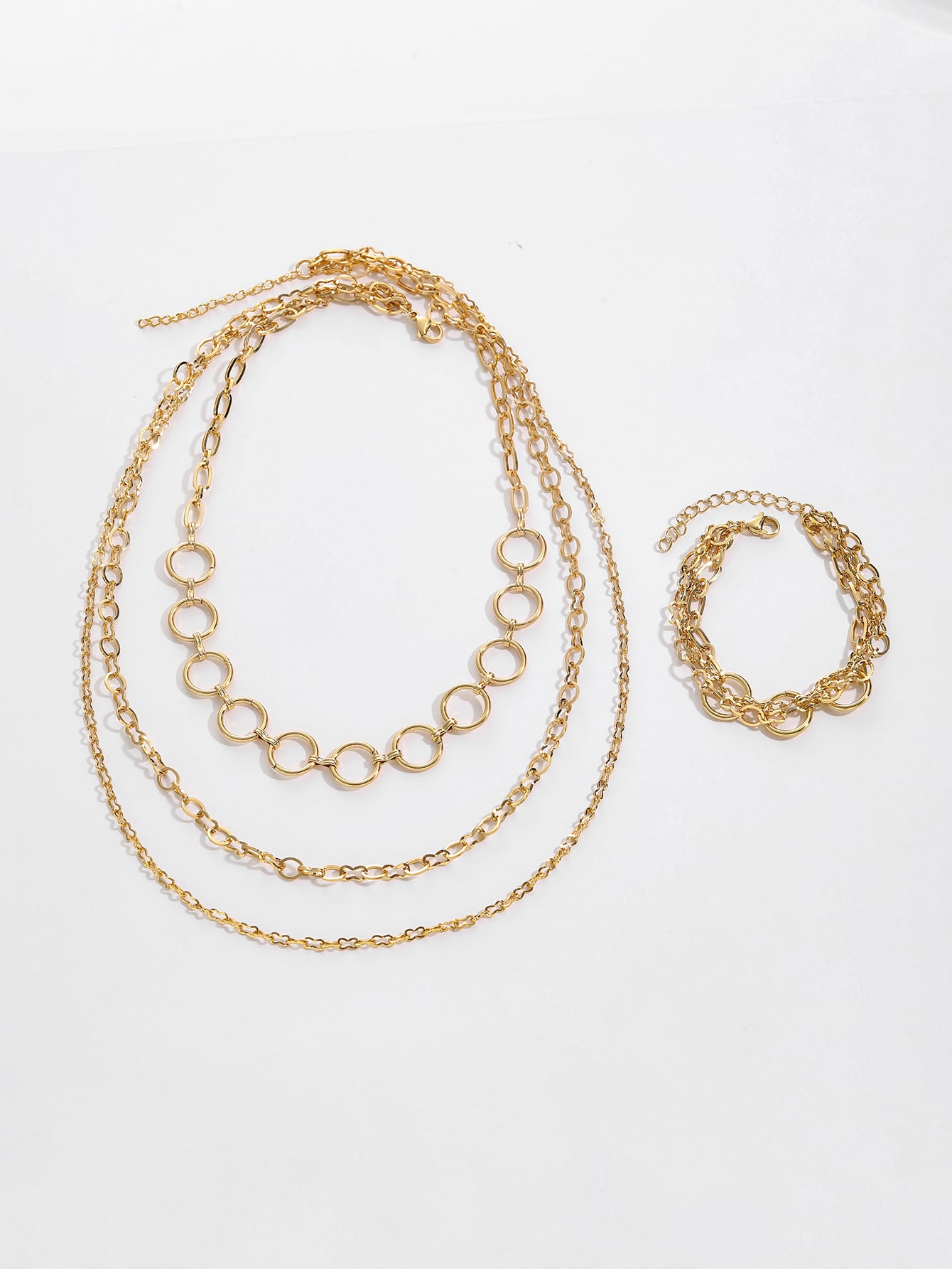 Halsband och armband i guld med cirklar